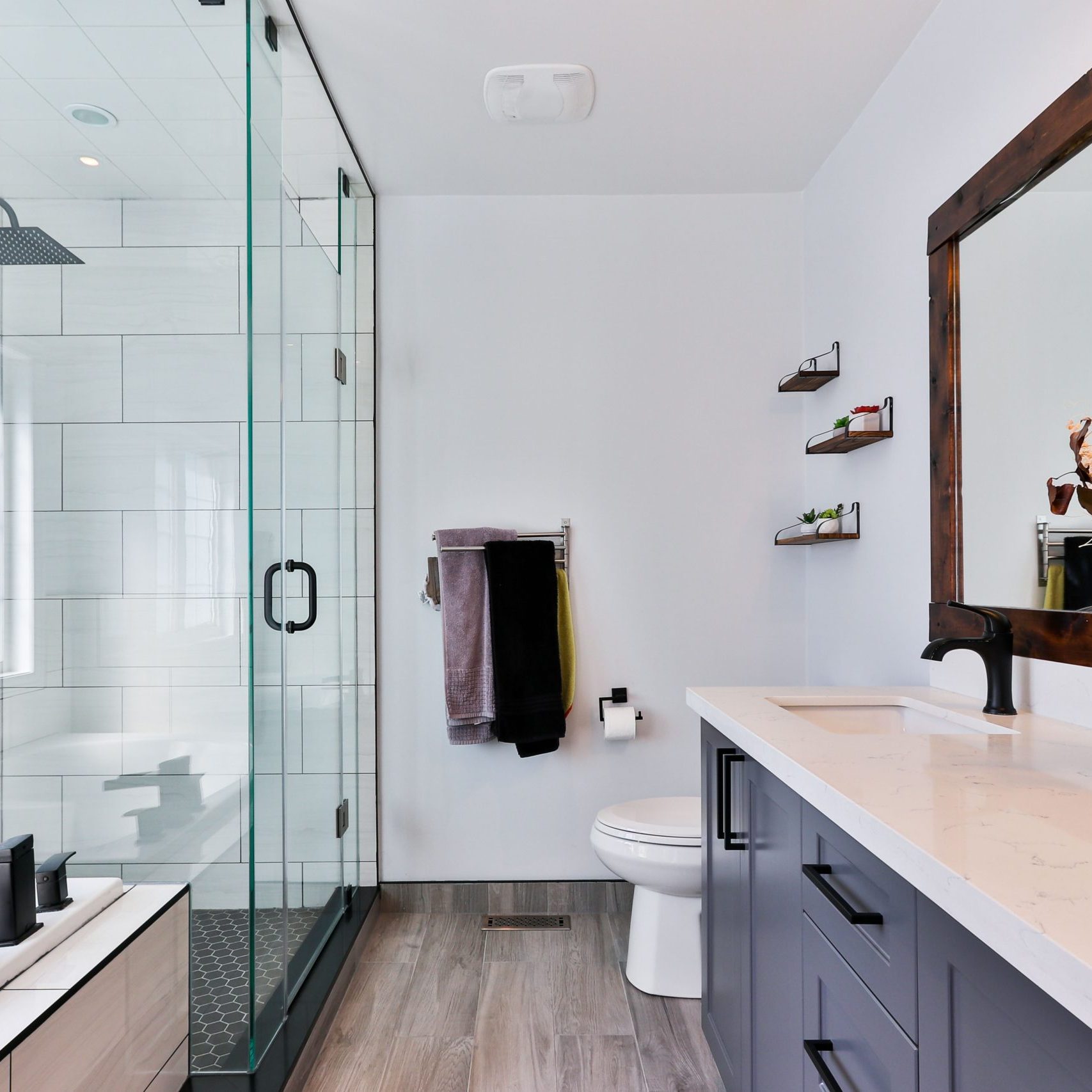 modern bathroom with glass shower, brihgt, open layout